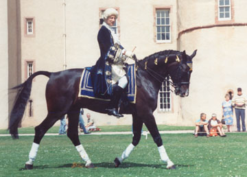 Roger displaying comfort in the saddle and dubious dress sense!